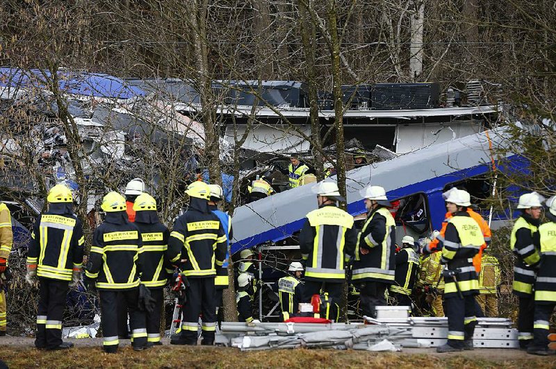 Rescue personnel stand in front of two trains that collided Tuesday near Bad Aibling in southern Germany. 