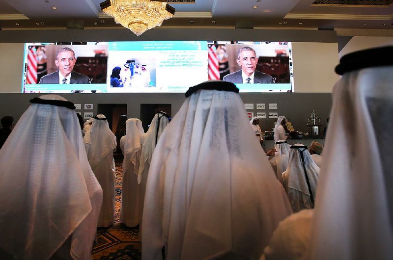 Emirati officials watch President Barack Obama’s keynote address Monday at the opening ceremony of the World Government Summit in Dubai, United Arab Emirates. The International Energy Agency said Tuesday that the world oil supply this year will continue to exceed demand. 