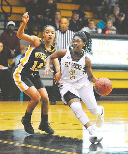 The Sentinel-Record/Mara Kuhn CONFERENCE CALL: Hot Springs’ Imani Honey (2) drives the ball against Watson Chapel’s Cayla Trotter in a 5A-South varsity girls’ game Tuesday night at Trojan Fieldhouse. Watson Chapel defeated Hot Springs, 58-44, for the second time in three games this season and remained unbeaten in conference play.