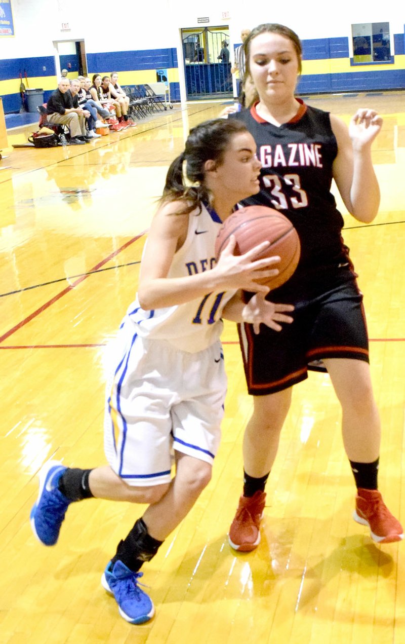 Photo by Mike Eckels Celine Prelle (Decatur #11) moves toward the basket around Reagan Pickartz (Magazine #33) during the Bulldog-Rattler girls&#8217; basketball game at Peterson Gym in Decatur Feb. 4.