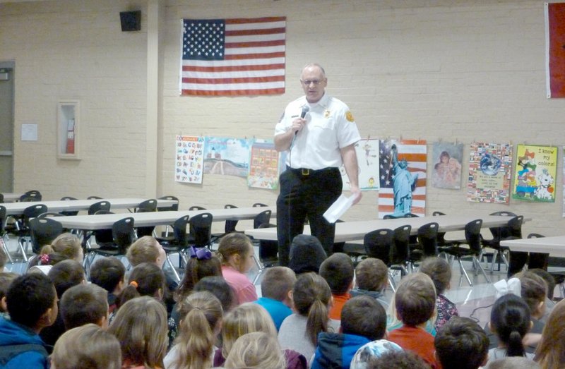 Submitted photo Steve Sims, Bella Vista fire chief, talked to Glenn Duffy Elementary School students about being honest at last week&#8217;s Rise and Shine assembly. He stressed how important it is for firefighters to be honest with each other. Sims also told the students about a contest to name Bella Vista&#8217;s new fire truck. Students who come up with the winning name will be given a tour of the Highlands fire station when it opens.