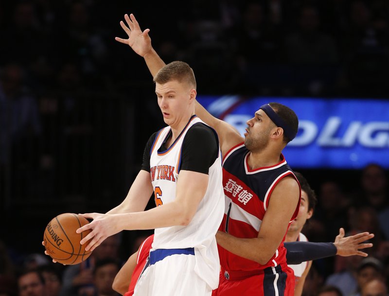 Washington Wizards forward Jared Dudley (1) defends New York Knicks forward Kristaps Porzingis (6) in the first half of an NBA basketball game at Madison Square Garden in New York, Tuesday, Feb. 9, 2016. 