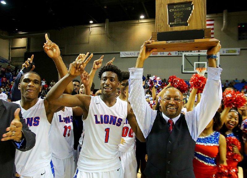 Little Rock McClellan's Karson Hayes, left, MVP Andre Jones (1) center, and coach Chris Threatt, right, celebrate after defeating Maumelle during the Class 5A Boys State High School Basketball Championships in Hot Springs, Ark. Saturday March 14, 2015.

