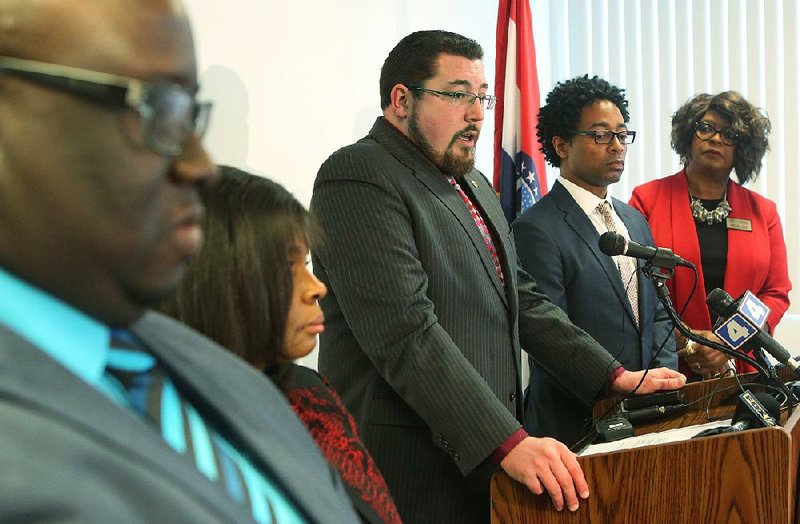 Ferguson, Mo., Mayor James Knowles (center) talks to reporters Wednesday along with (from left) City Manager DeCarlon Seewood, council members Laverne Mitchom, Wesley Bell and Ella Jones. 