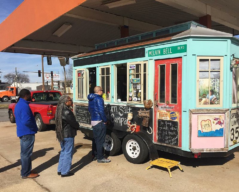 Diners line up outside the Southern Salt Food Co. truck, parked at The Food Truck Stop @ Station 801 in downtown Little Rock. 