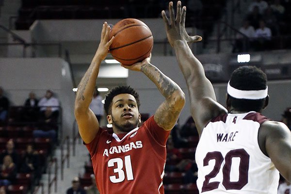 Arkansas guard Anton Beard (31) attempts a shot past the defense of Mississippi State forward Gavin Ware (20) in the first half of an NCAA college basketball game in Starkville, Miss., Tuesday, Feb. 9, 2016. Mississippi State won 78-46. (AP Photo/Rogelio V. Solis)

