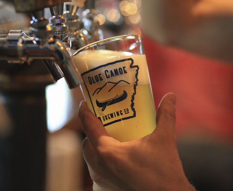 FILE — Bar tender Patrick Cowan pours a pint of beer at the Blue Canoe Brewing Company on E. Third Street in Little Rock in this June 2015 file photo.
