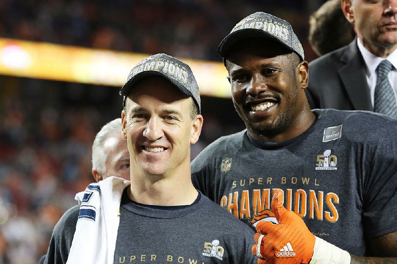 Denver Broncos’ Von Miller (58) and QB Peyton Manning (18) are seen post-game after a win against the Carolina Panthers after the NFL Super Bowl 50 football game Sunday, Feb. 7, 2016, in Santa Clara, Calif.  