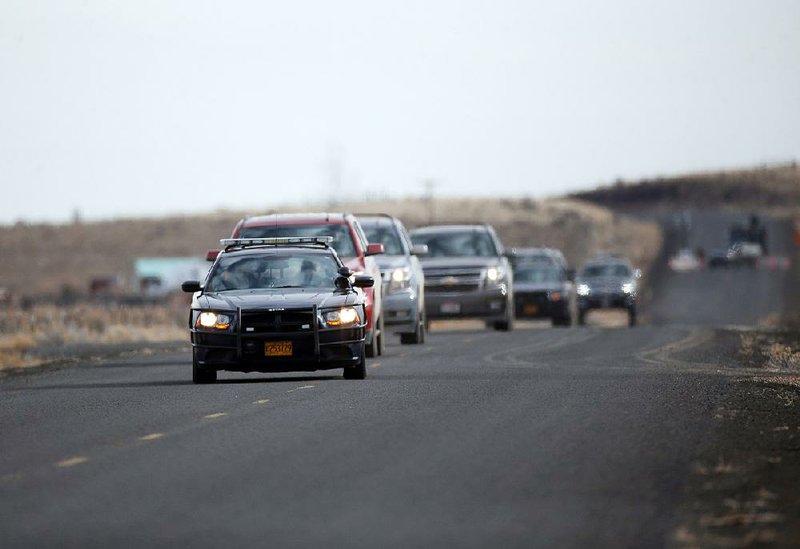 Authorities lead a caravan of the final four occupiers of the Malheur National Wildlife Refuge through a roadblock on Thursday near Burns, Ore. 