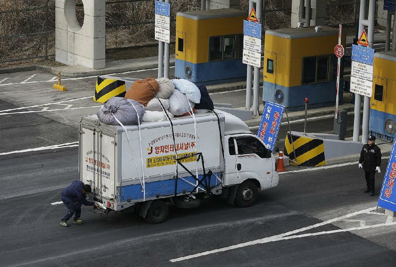 A South Korean driver changes his vehicle number plate after returning from North Korea’s joint Kaesong Industrial Complex at the customs, immigration and quarantine office near the border village of Panmunjom in Paju, South Korea, on Thursday. 