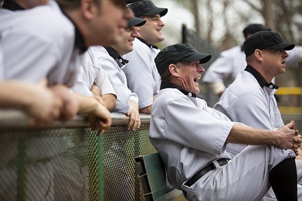 Hodge Kirby, laughing, reacts to a play from the dugout with fellow stand-ins dressed in 1912's baseball uniforms on Saturday, March 21, 2015 at Lamar Porter Athletic Field in Little Rock.The men performed as ball players for Larry Foley's upcoming film about the history of spring training in Arkansas. 
