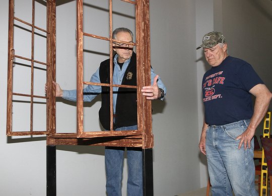 The Sentinel-Record/Lorien E. Dahl OPEN AND SHUT: Director Bill Lamoureux, left, looks over the " Angry Men" jury room set window with the man who will portray Juror No. 10, Ken Silvers. Set construction for the play is being led by Bob Feckler. Tickets can be purchased online at http://www.hsvpoa.org.