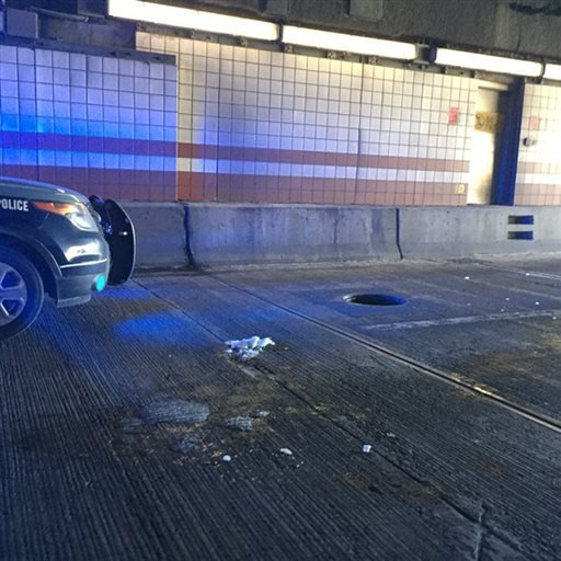 A police vehicle is parked in front of a manhole cover at the Thomas P. O’Neill Tunnel on Friday, Feb. 12, 2016, in Boston.