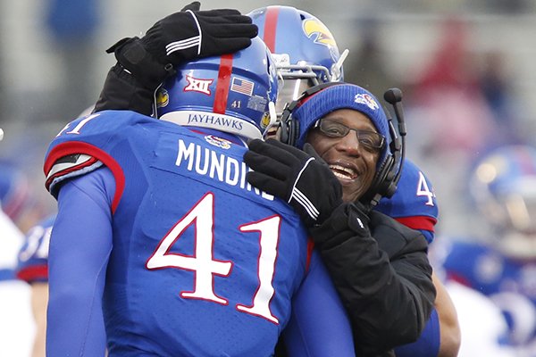 Kansas tight end Jimmay Mundine is congratulated by running backs coach Reggie Mitchell after his touchdown against TCU during the second quarter on Saturday, Nov. 15, 2014, at Memorial Stadium in Lawrence, Kan.