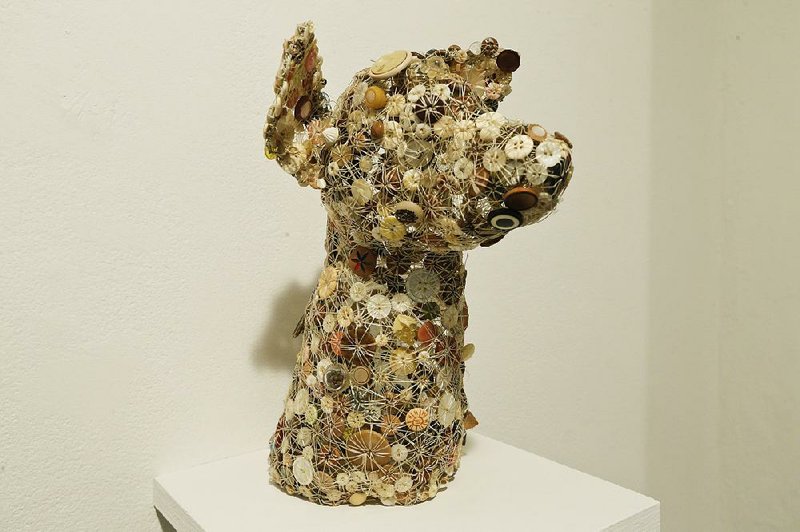 A bust of a dog by San Francisco-based artist Lisa Kokin is shown at the Rush Arts Gallery in New York for “The Button Show.” 
