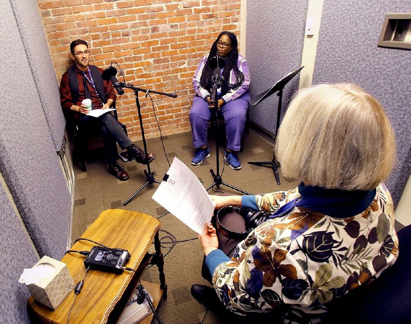 Script in hand, Glenn Whaley (right) talks about recording an episode of Radio CALS at the Butler Center for Arkansas Studies with voice artists and library employees Rhonda Stewart (center), a genealogy specialist, and Stewart Fuell, who works with programs for adults.