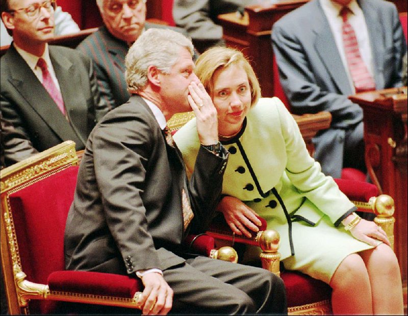 President Bill Clinton whispers to his wife, Hillary Rodham Clinton, before delivering his “Presidents’ Day” proclamation in 2000.