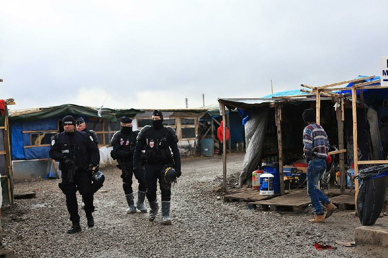 French riot police patrol earlier this month around the migrant camp in Calais, which has been targeted by armed attackers.