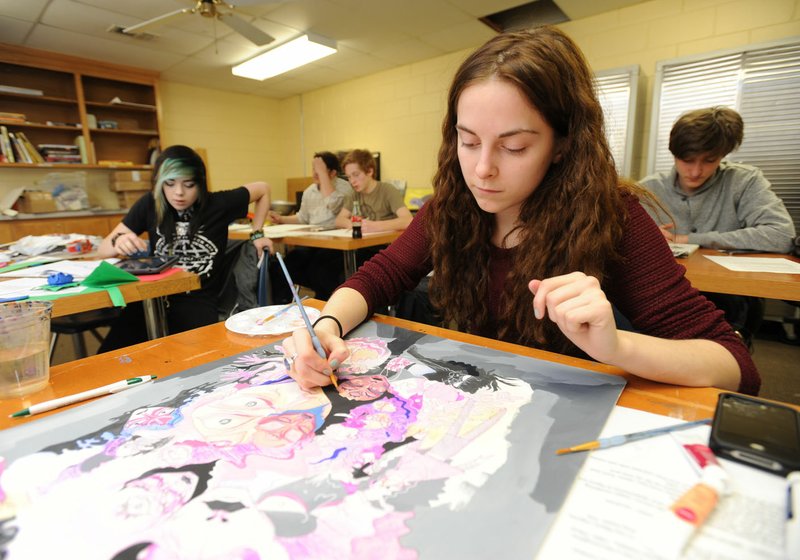 Stevie Petet (center), 17, a senior at the Arkansas Art Academy in Rogers, works Thursday on a self-portrait titled Constructed Base in a classroom at the school. The school is working with donors to expand and renovate the high school building in downtown Rogers, according to school CEO Mary Ley.
