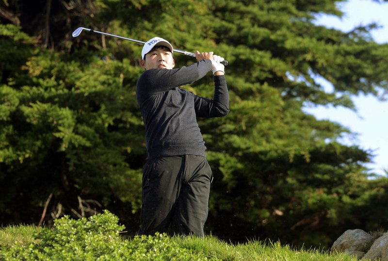 Sung Kang, of South Korea, hits from the 11th tee of the Monterey Peninsula Country Club Shore Course during the second round of the AT&amp;T Pebble Beach National Pro-Am golf tournament Friday, Feb. 12, 2016, in Pebble Beach, Calif. Kang co-leads the tournament after shooting an 11-under-par 60. (David Royal/Monterey Herald via AP) 