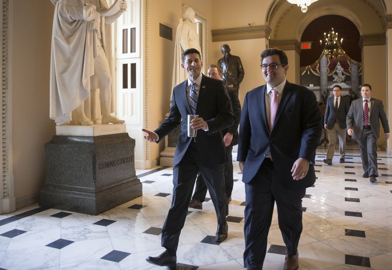 House Speaker Paul Ryan of Wis., center, walks to the House chamber on Capitol Hill in Washington, Friday, Feb. 12, 2016, as Republicans and Democrats joined together to overwhelmingly approve legislation that hits North Korea with more stringent sanctions for refusing to stop its nuclear weapons program.  
