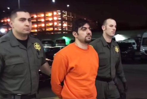 Orange County sheriff's department deputies escort Hossein Nayeri back to the Central Men's jail in Santa Ana, Calif., in the early morning hours of Sunday, Jan. 31, 2016. Authorities suspect Nayeri was the mastermind of the breakout in which three inmates escaped.