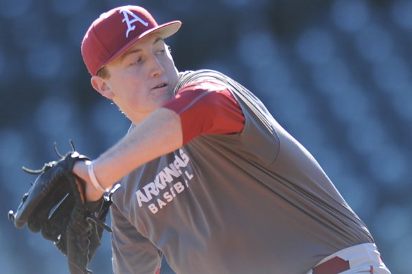 Zach Jackson of Arkansas delivers a pitch Friday, Jan. 29, 2016, during practice at Baum Stadium in Fayetteville.