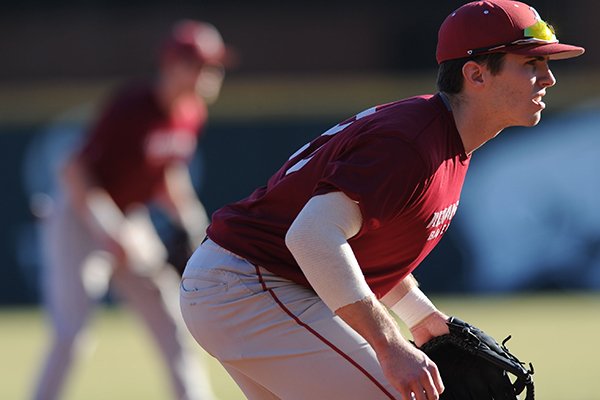 Carson Shaddy (right) of Arkansas prepares for the pitch Friday, Jan. 29, 2016, during practice at Baum Stadium in Fayetteville.