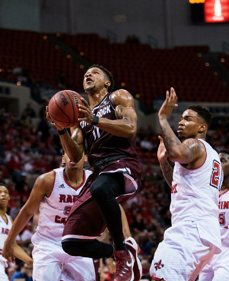 UALR guard Jermaine Ruttley (center) came off the bench to score nine points and pull down six rebounds as the Trojans beat Louisiana-Lafayette 68-64 on Saturday.