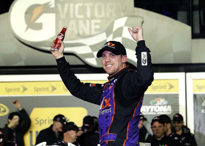 Denny Hamlin celebrates in Victory Lane after winning the Sprint Unlimited auto race at Daytona International Speedway, Saturday, Feb. 13, 2016, in Daytona Beach, Fla.