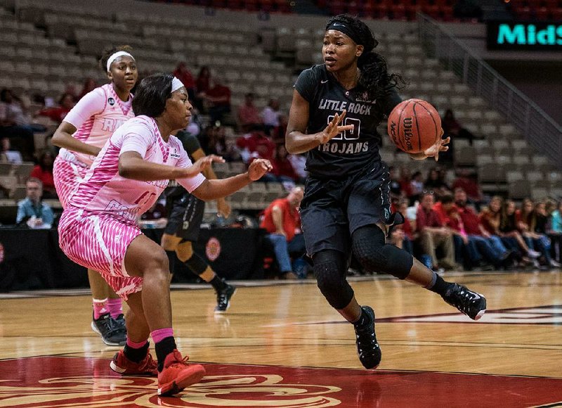 UALR forward Shanity James drives the lane during the first half of Saturday’s game against Louisiana-Lafayette at the Cajundome in Lafayette, La. James finished with 22 points and 12 rebounds as UALR won 58-49.