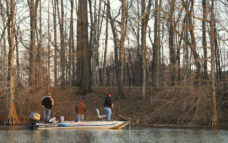 In this file photo three fishermen cast for bass on the Little Maumelle River near Two Rivers Park in Little Rock.