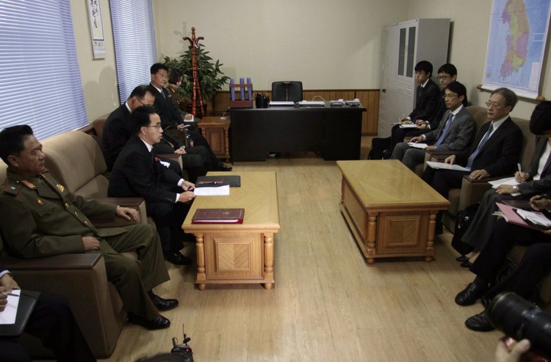  In this Oct. 29, 2014 file photo, North Korea's Land and Environmental Protection Director Kim Hyon Chol, second left, accompanied by North Korea's Special Investigation Committee Vice-Director Kim Myong Chol, left, speaks to Japan's Foreign Ministry Asia and Oceania Affairs Bureau Director General Junichi Ihara, second right, during their talks on abduction probe at the Special Investigation Committee office in Pyongyang, North Korea, assessing progress into an investigation of the fates of Japanese citizens abducted by North Korea in the 1970s and '80s. 