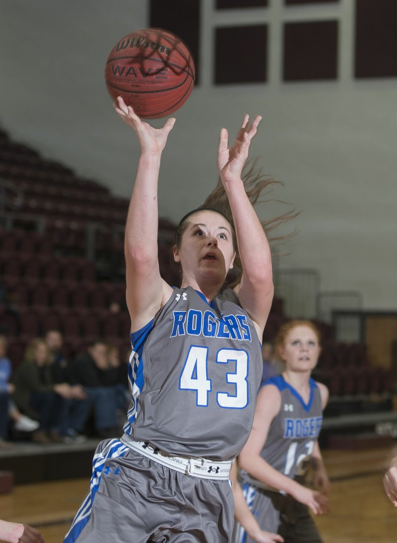 Samantha Brown, Rogers senior, shoots Wednesday against Siloam Springs at Panther Gymnasium in Siloam Springs.