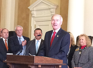 Gov. Asa Hutchinson tells more than 20 legislators and officials at a press conference Tuesday, Feb. 16, 2016, that supporting Arkansas Works is not the same as supporting the Affordable Care Act. 