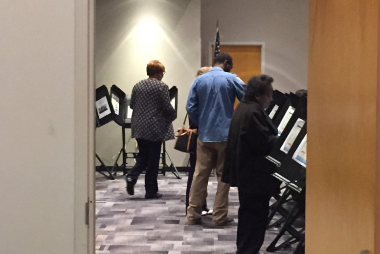 The first voters fill out their ballots for primary candidates at the start of Arkansas' early voting period Tuesday, Feb. 16. 