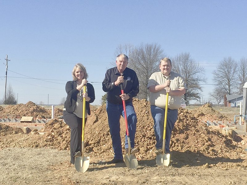 SUBMITTED PHOTO Shelly Johnson, left, Gene Pharra and Daniel Keeton with Farm Credit of Western Arkansas, held a groundbreaking at the location of their new office on Heritage Parkway in Prairie Grove. The office will open in early summer.