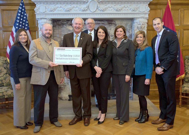 Submitted Photo Pictured with the grant check are: Cassie Elliott (left), Mayor Greg Barber, Governor Asa Hutchinson, ARDC Commissioner Lonnie Turner, AEDC Rural Services director Alex Johnston, ARDC chair Jamie Pafford-Gresham, AEDC deputy director Amy Fecher, and AEDC executive director Mike Preston. Not Pictured are: Senator Jim Hendren and Representative Kim Hendren.