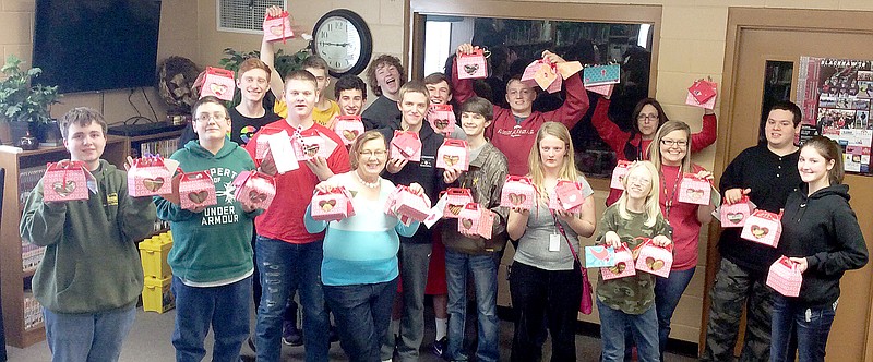 Pea Ridge High School students and their community service project sponsor, teacher Londa Keever, show a few of the Valentine boxes they prepared as part of their Spread a Little Love project.