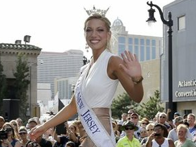 In this Sept. 3, 2013, file photo Miss New Jersey Cara McCollum waves as she walks on a runway as Miss America contestants arrive in Atlantic City, N.J. 