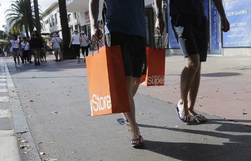 Shoppers walk along Lincoln Road Mall, a pedestrian area of retail shops and restaurants in Miami Beach in this file photo. Inflation showed signs of acceleration in January, according to a Labor Department report Friday. 