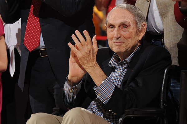 Former Arkansas coach Eddie Sutton (center) watches Saturday, Feb. 20, 2016, as he is surrounded by family, administrators and former players as a banner honoring him is dedicated in Bud Walton Arena during a ceremony at halftime in Fayetteville. Sutton coached Arkansas from 1974 to 1985 and led the Razorbacks to the Final Four and a third-place finish in 1978.