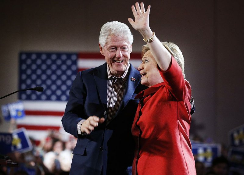Former President Bill Clinton celebrates with Hillary Clinton in Las Vegas after she finished first in the Nevada Democratic presidential caucuses.