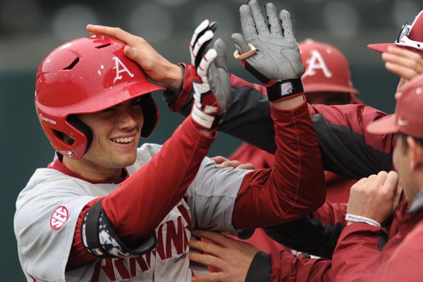 Clark Eagan (9) of Arkansas is congratulated by teammates after hitting a 2-run home run against Mississippi Valley State Tuesday, Feb. 23, 2016, during the second inning at Baum Stadium in Fayetteville.