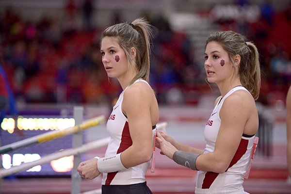 Tori Weeks (left) and Lexi Weeks of Arkansas prepare to compete in the pole vault invitational on Saturday, Feb. 13, 2016, during the second day of the Tyson Invitational indoor track meet at the Randal Tyson Track Center in Fayetteville.