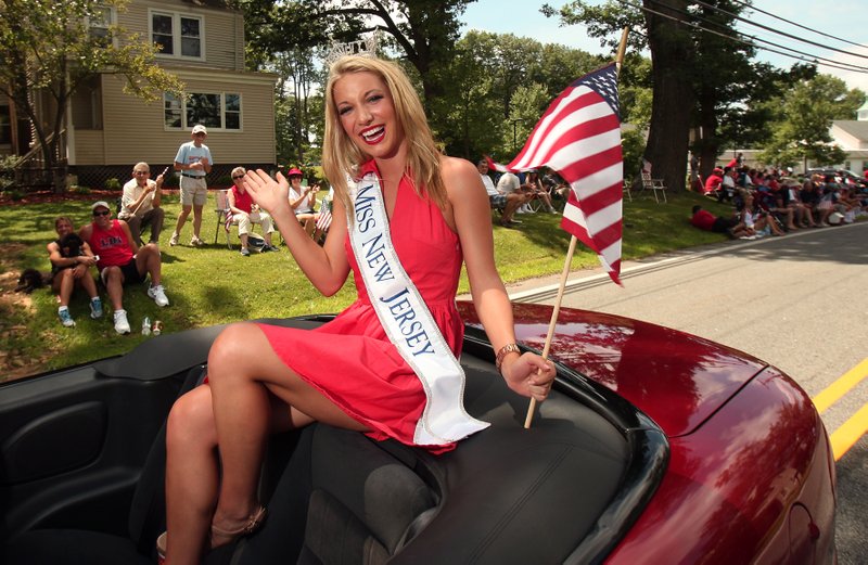 In this July 6, 2013 photo, Miss New Jersey Cara McCollum waves during the annual Randolph Freedom Fest Parade in Randolph, N.J. McCollum, who was critically injured in a car crash on a New Jersey highway last week, died at Cooper University Hospital early Monday, Feb. 22, 2016. Her family says in a Facebook post that she died with her family by her side in an operating room. (Bob Karp/The Daily Record via AP) 