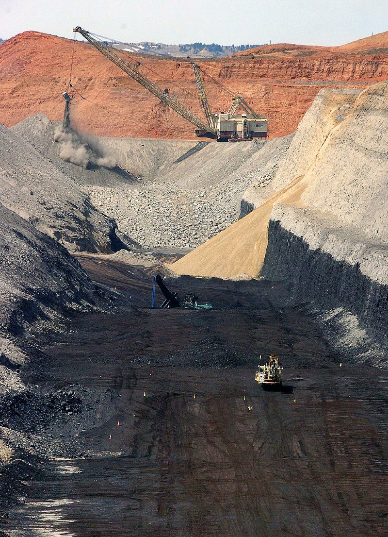 Strip miners work on an 80-foot thick coal seam at Cloud Peak Energy’s Spring Creek mine near Decker, Mont., in this file photo. The Northern Plains coal seams once appeared nearly limitless, but a government analysis says the region’s coal reserves, the nation’s largest, will be tapped out in just a few decades.