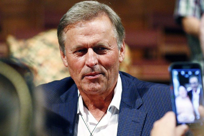 Best selling author and former Mississippi lawmaker John Grisham has a "selfie" photograph taken with an attendee of the Mississippi Book Festival, at Galloway Methodist Church Sanctuary, Saturday, Aug. 22, 2015 in Jackson, Miss. 
