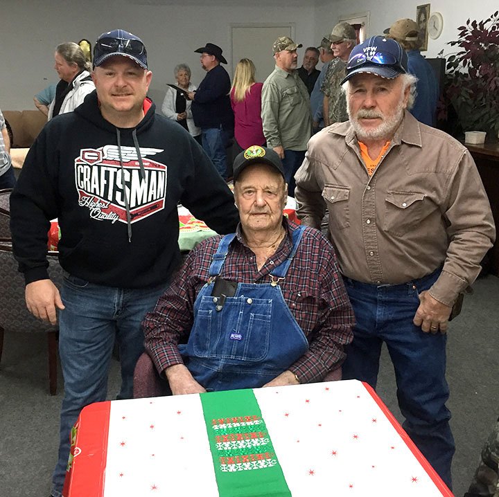 Submitted Photo Clifford Barnes (seated) was honored Dec. 5 by members of the Howard-Parrish Veterans of Foreign Wars post 9834. With Barnes is his son Reuben (right) and his grandson Shane (left).