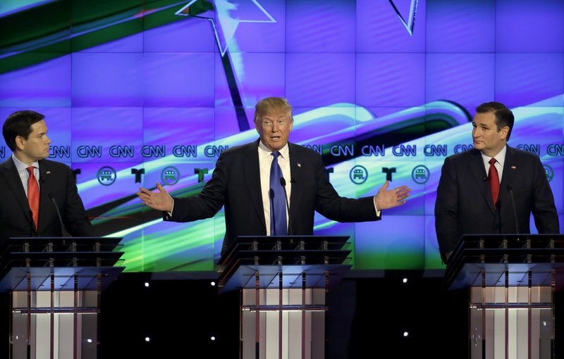 Republican presidential candidate, businessman Donald Trump, center, speaks as Republican presidential candidate, Sen. Marco Rubio, R-Fla., left and Ted Cruz, R-Texas look on during a Republican presidential primary debate at The University of Houston, Thursday, Feb. 25, 2016, in Houston. (AP Photo/David J. Phillip)